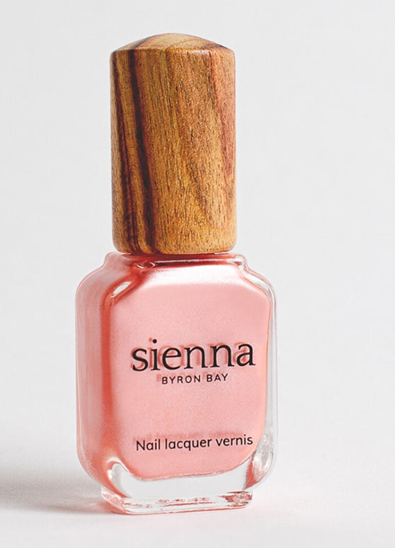 Sienna Charm soft pink shimmer nail polish bottle with timber cap